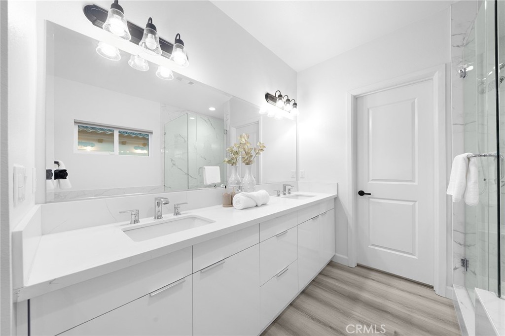 1359 Point Loma Place Walnut, CA 91789 - Photo 45 of 75 a en suite bathroom with a double vanity sink a mirror and a shower