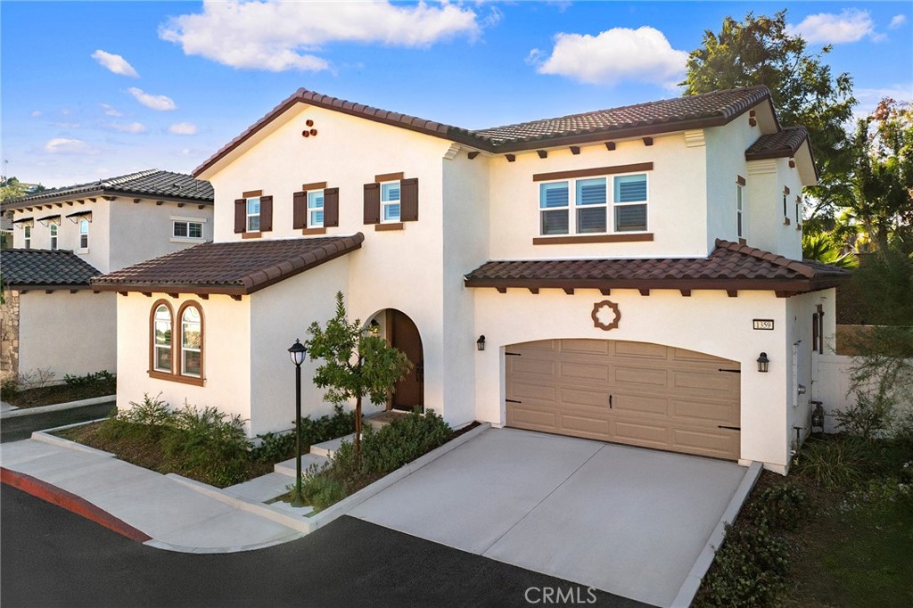 1359 Point Loma Place Walnut, CA 91789 - Photo 5 of 75 a front view of a house with a yard and garage