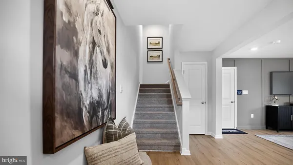 a view of a hallway with wooden floor and staircase