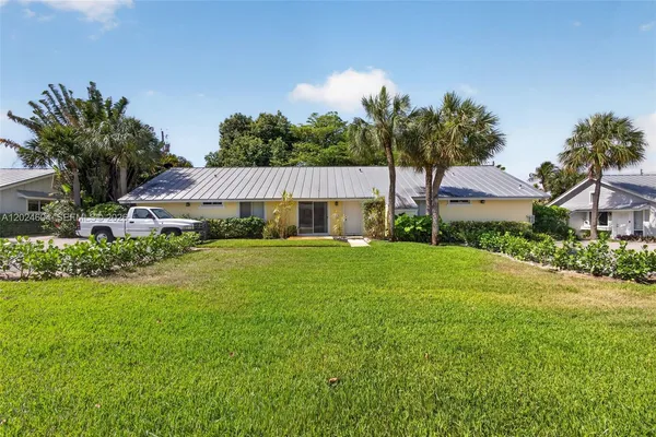 a view of an house with backyard space and garden