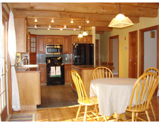 12 River Road Merrimac, MA 01860 - Photo 20 of 28 a living room with stainless steel appliances kitchen island granite countertop furniture a rug and a view of kitchen