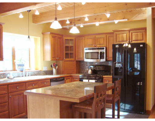 12 River Road Merrimac, MA 01860 - Photo 7 of 28 a kitchen with a sink a center island a stove and a window