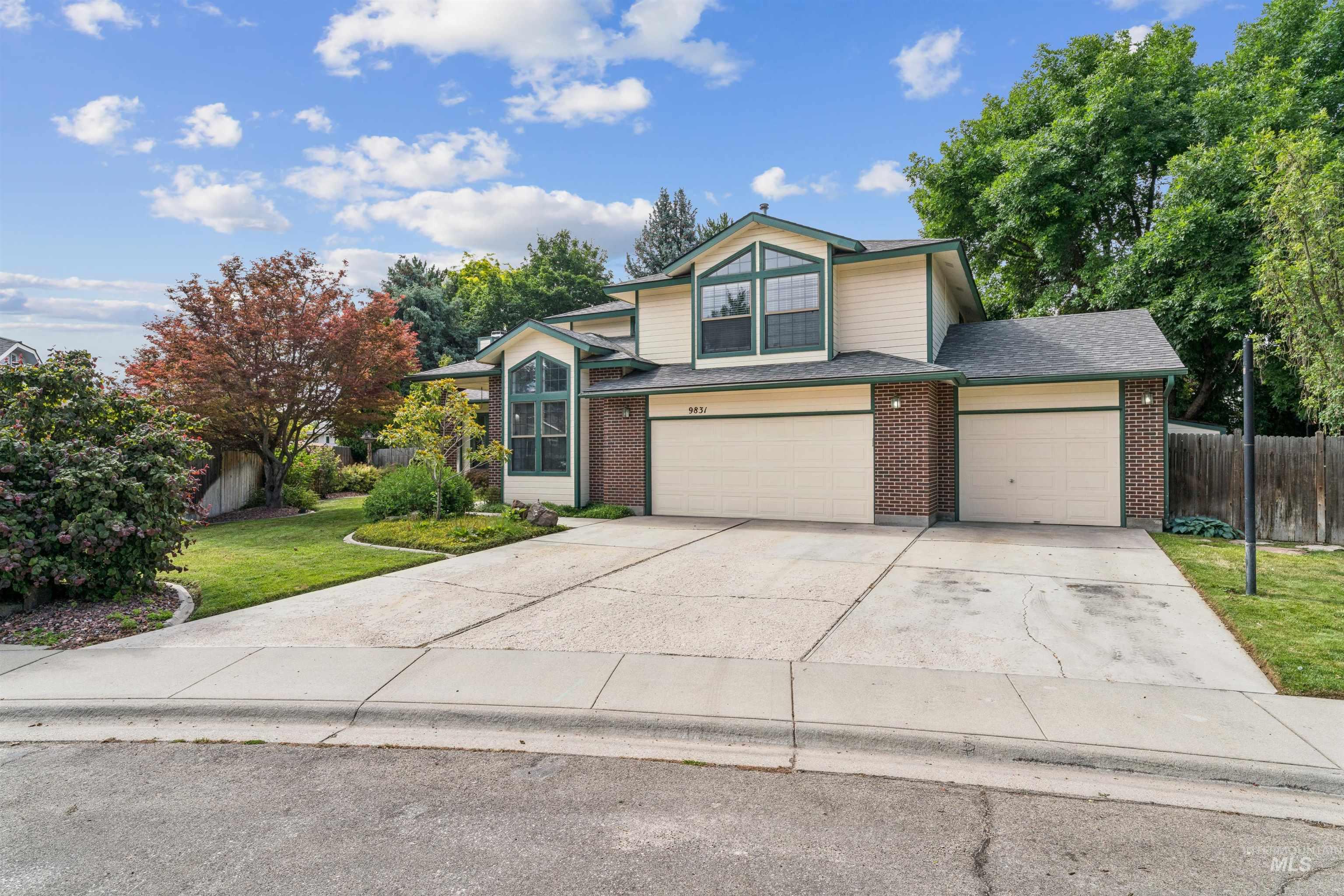 9831 West Ripley Street Boise, ID 83704 - Photo 41 of 47 Expansive backyard featuring a raised deck, a detached storage shed, a pergola-covered patio, mature trees, and landscaped garden beds