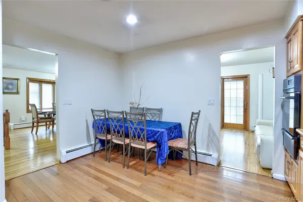 a bedroom with two beds and wooden floor