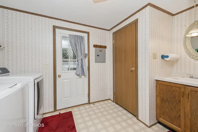 a view of a hallway with closet and utility room
