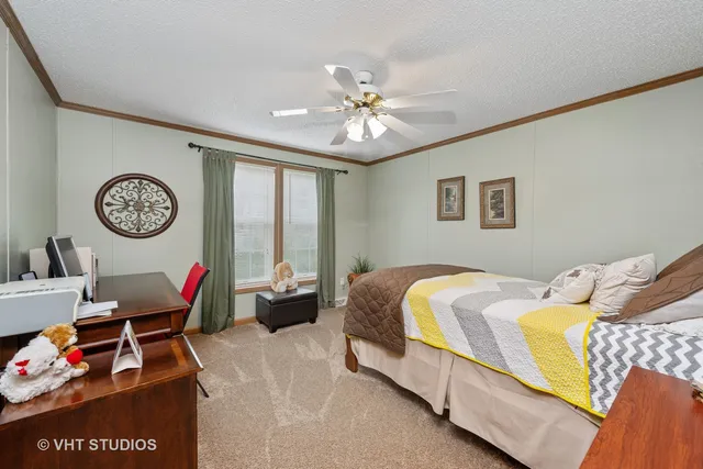 a bedroom with a bed and a chandelier