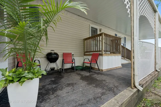 a backyard of a house with table and chairs