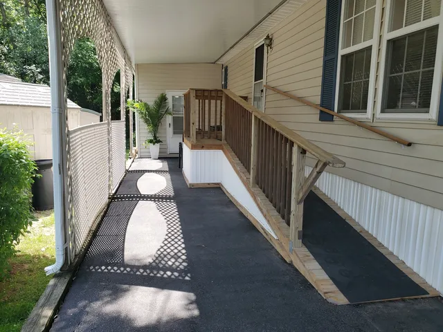 a view of a balcony with wooden floor and stairs