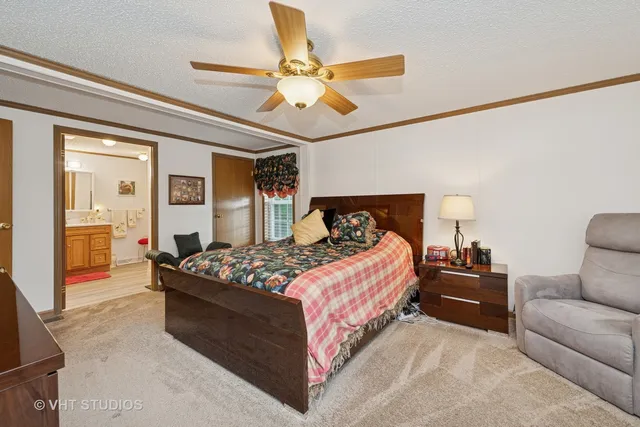 a bedroom with a bed and ceiling fan