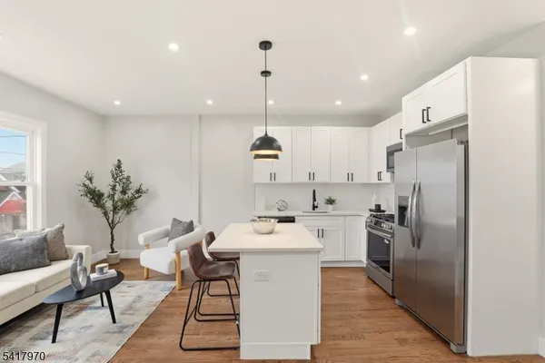 a kitchen with a sink appliances and cabinets