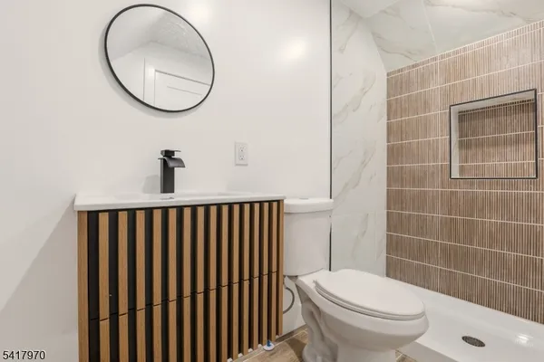 a bathroom with a toilet and a mirror