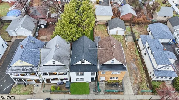 an aerial view of multiple houses with a yard