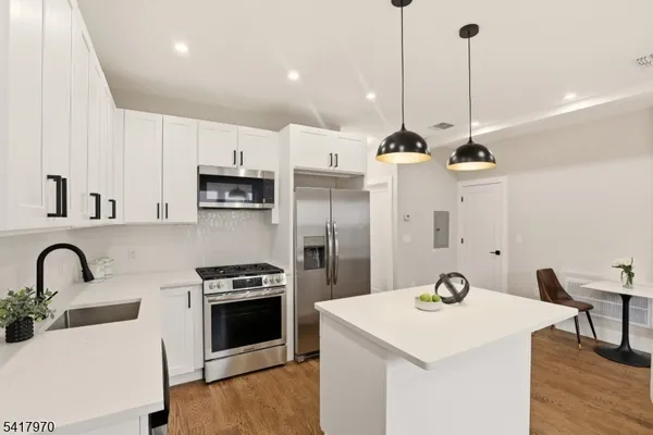 a kitchen with a sink a counter and stainless steel appliances