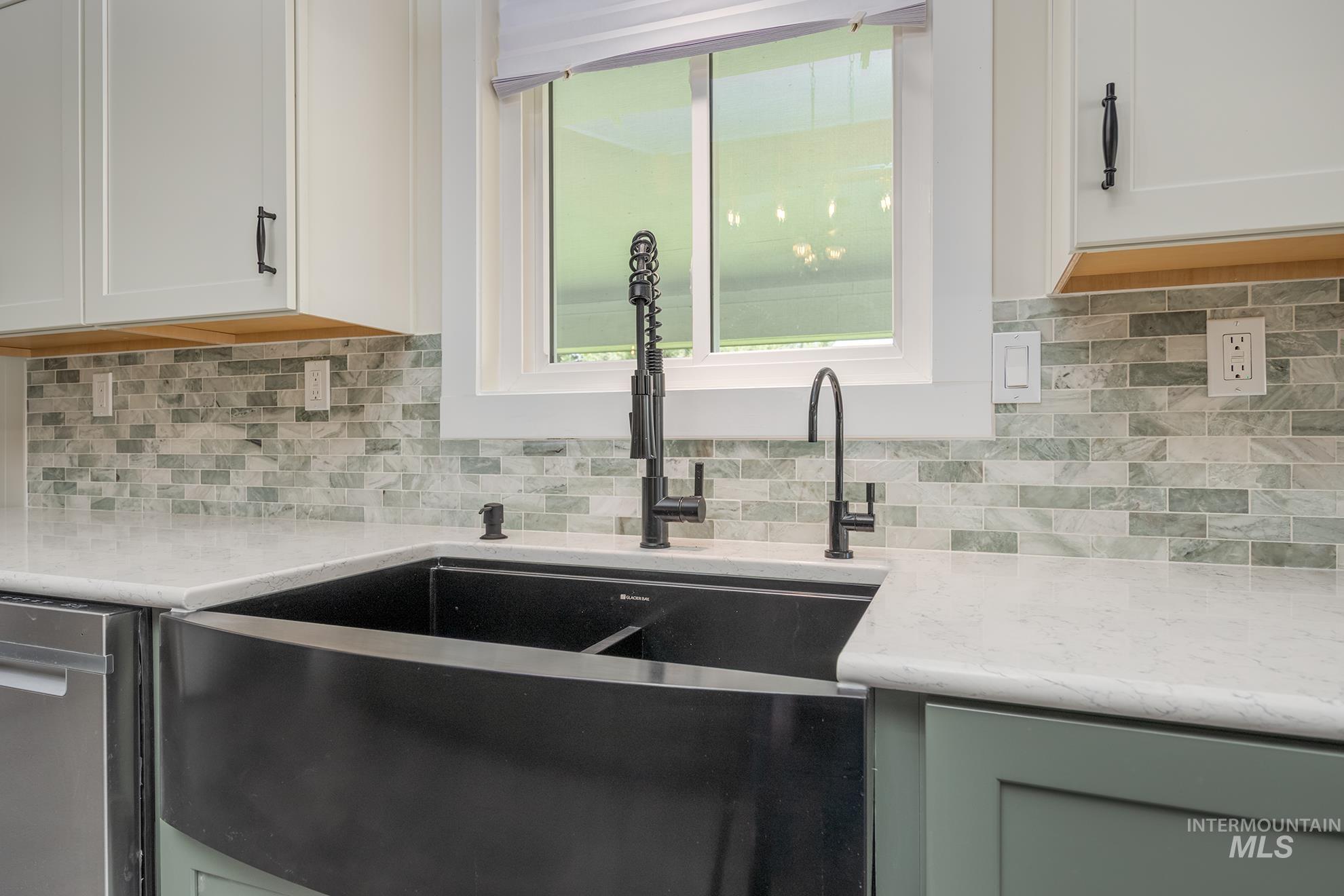748 Pringle Road Weiser, ID 83672 - Photo 9 of 47 Modern kitchen sink area featuring a black apron-front sink and matte black fixtures