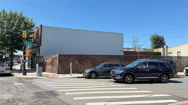 a view of a cars parked on the side of a street