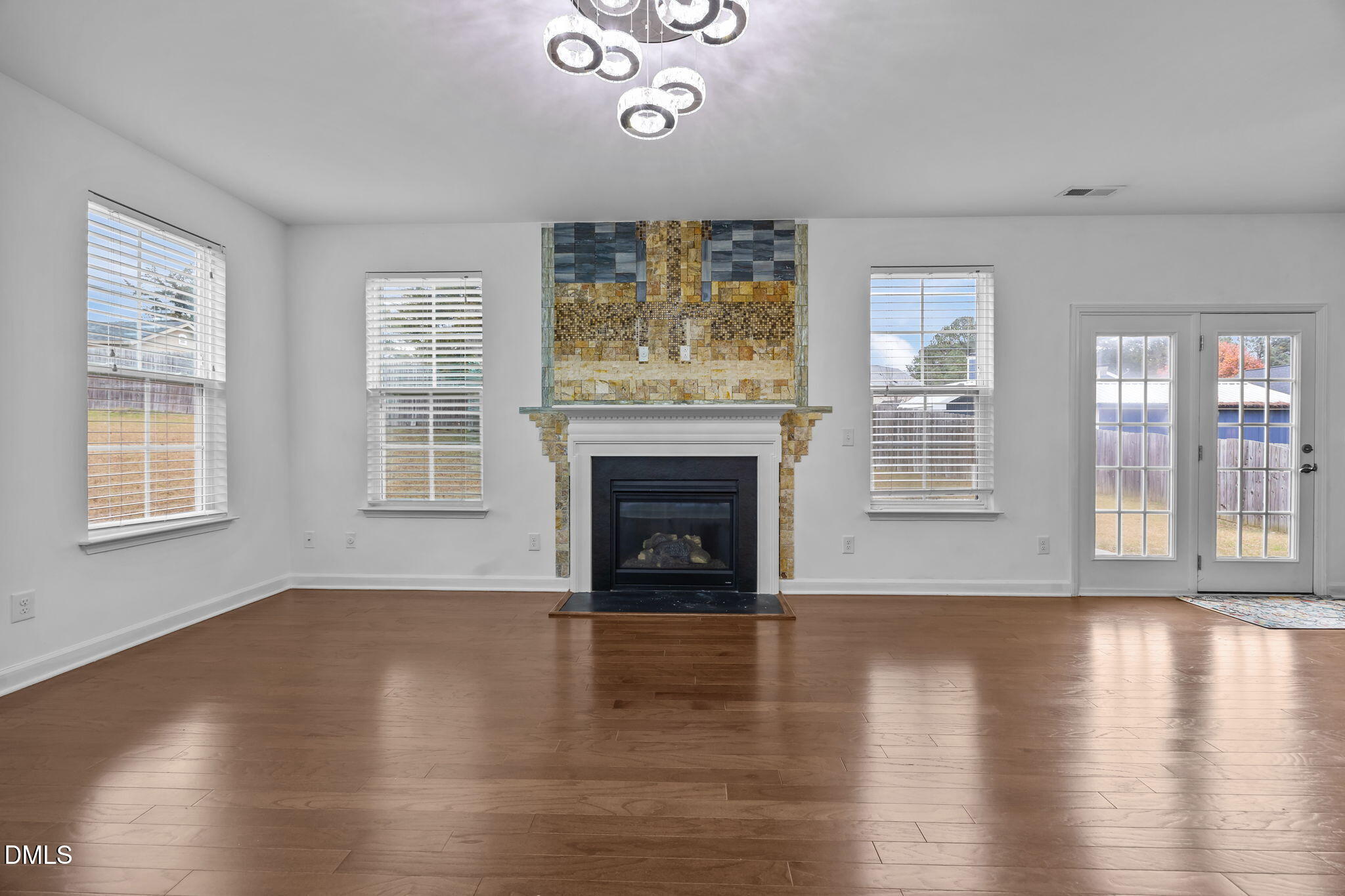 3409 South Beaver Lane Raleigh, NC 27604 - Photo 12 of 31 a view of an empty room with wooden floor and a window