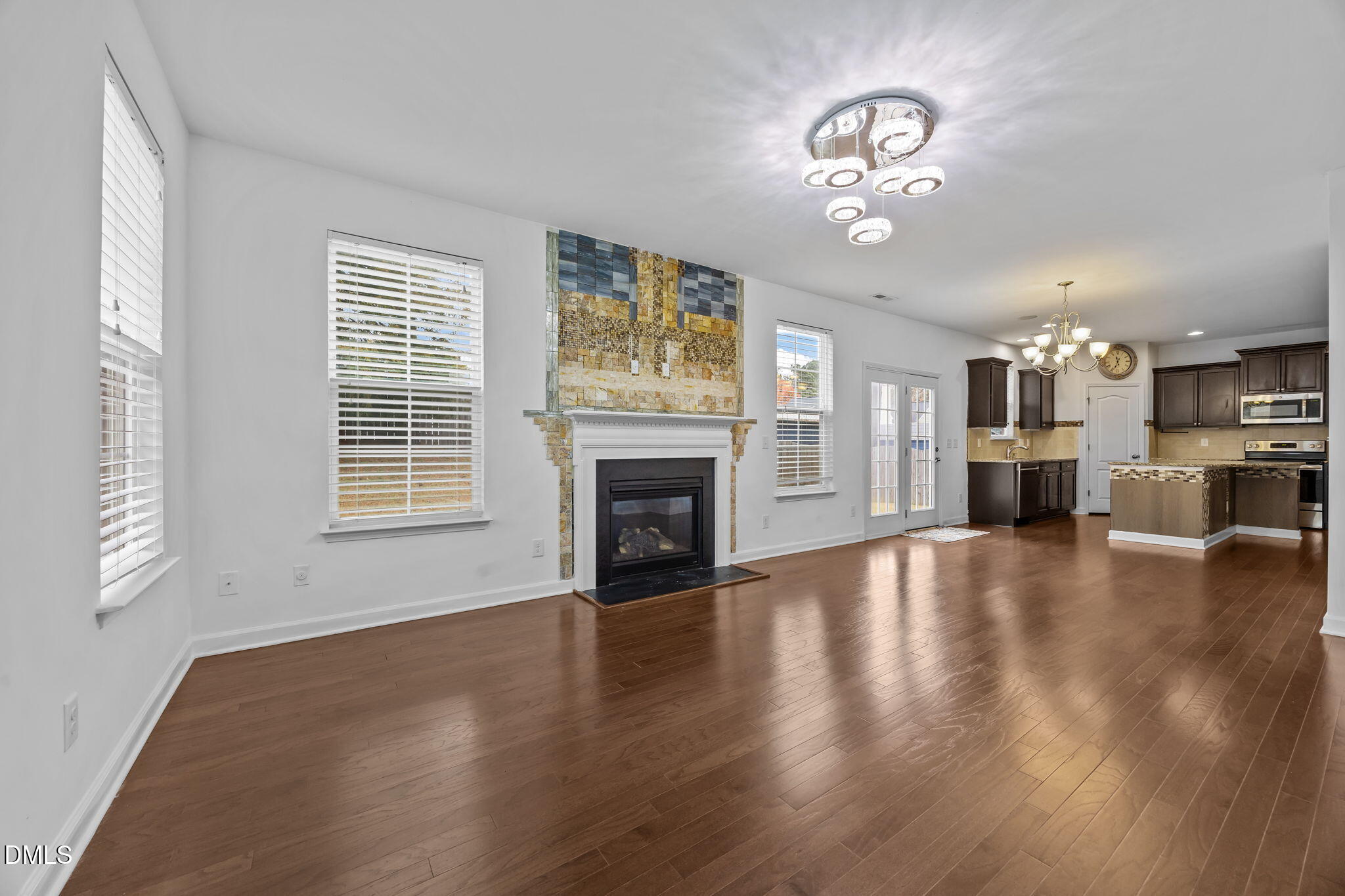 3409 South Beaver Lane Raleigh, NC 27604 - Photo 13 of 31 a view of a livingroom with a fireplace wooden floor and windows