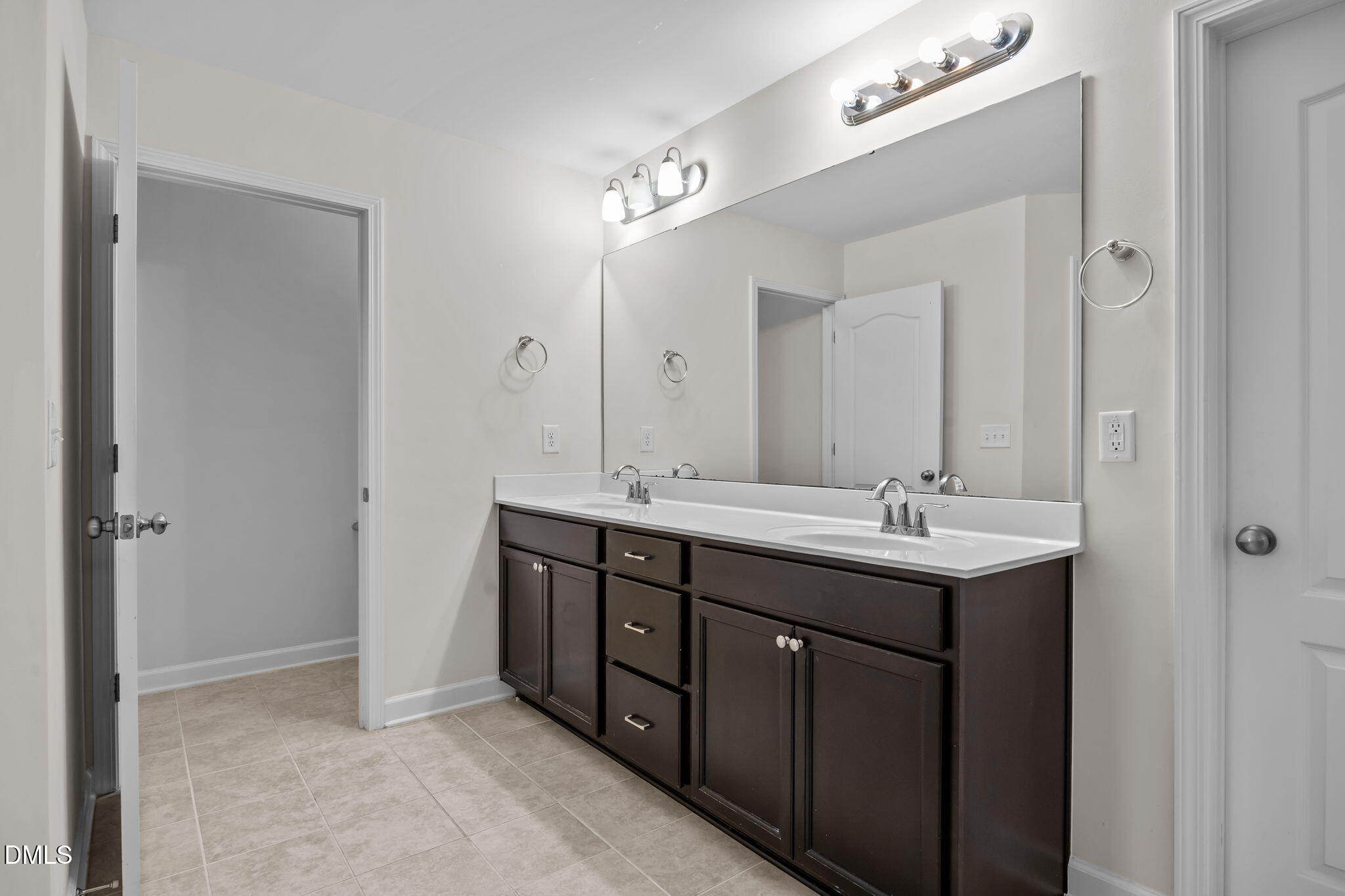 3409 South Beaver Lane Raleigh, NC 27604 - Photo 29 of 31 a bathroom with a double vanity sink and mirror
