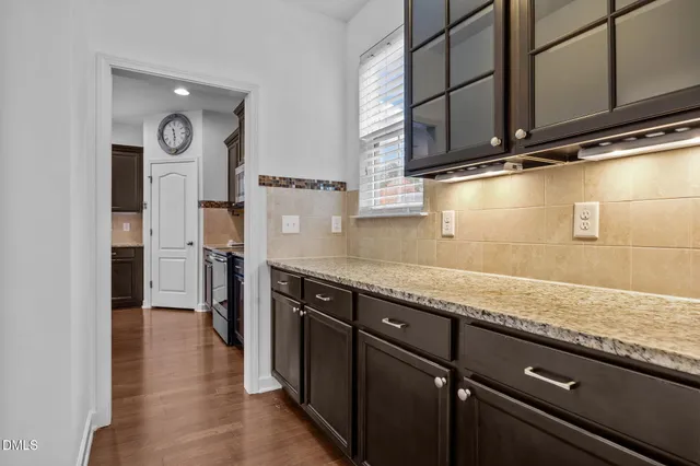 a kitchen with stainless steel appliances granite countertop a refrigerator a stove and a sink