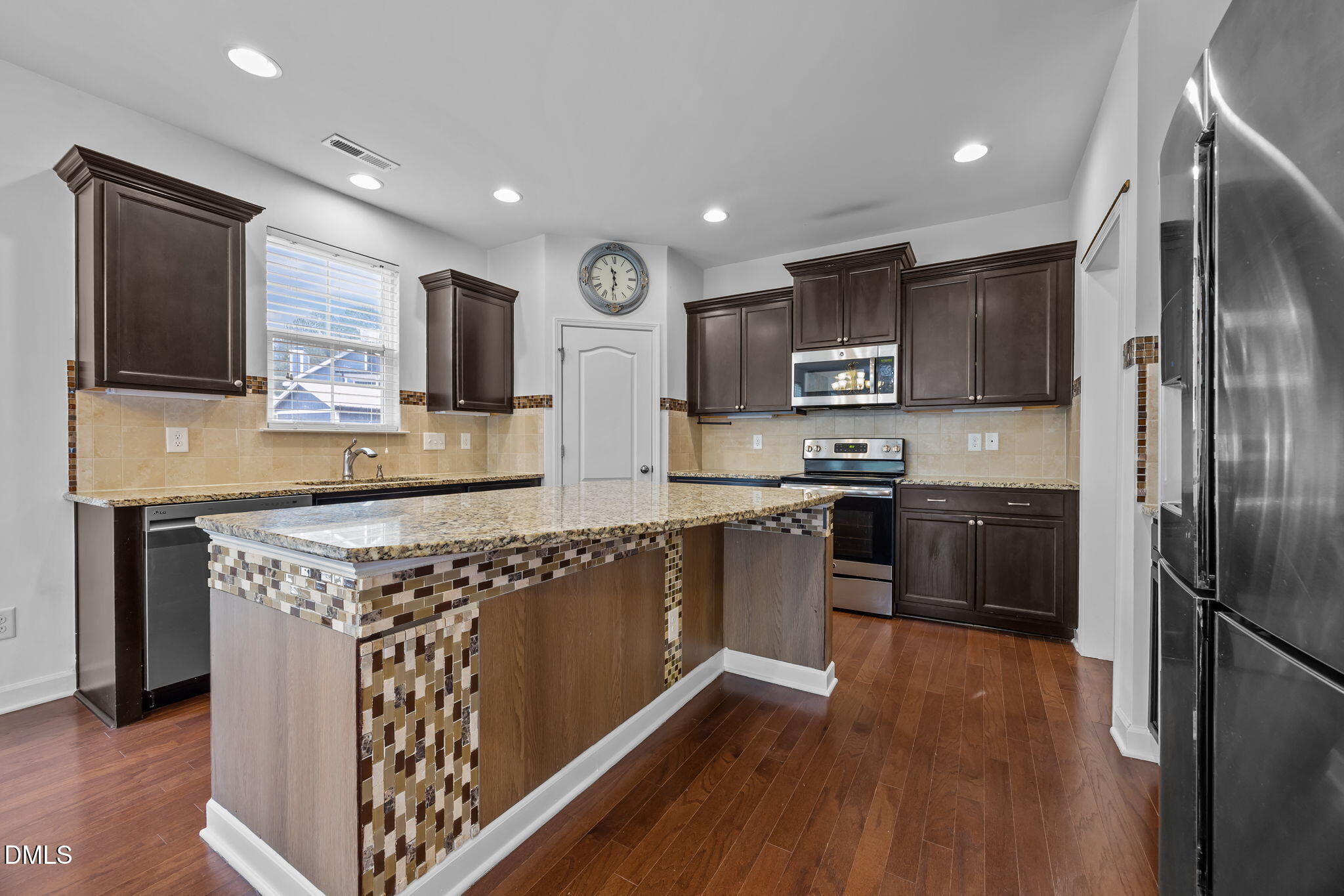 3409 South Beaver Lane Raleigh, NC 27604 - Photo 7 of 31 a kitchen with stainless steel appliances granite countertop a refrigerator a stove top oven a sink and dishwasher