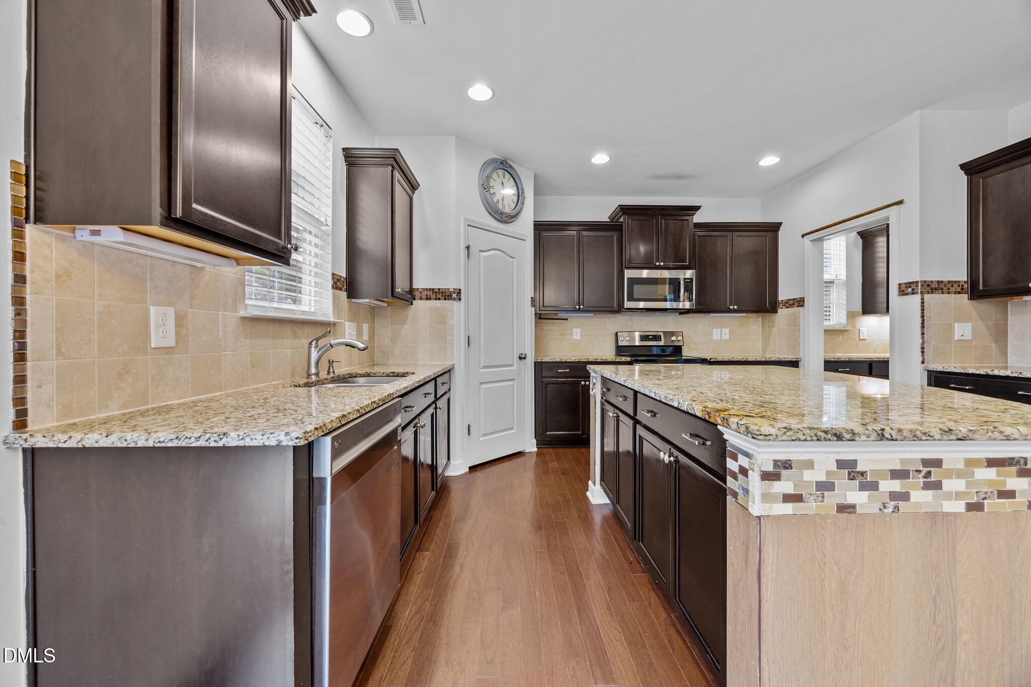 3409 South Beaver Lane Raleigh, NC 27604 - Photo 8 of 31 a kitchen with stainless steel appliances granite countertop a sink stove and refrigerator