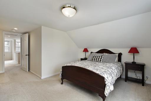 1010 Raleigh Road Glenview, IL 60025 - Photo 12 of 16 a bedroom with a bed and a chandelier