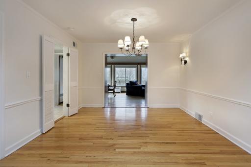 1010 Raleigh Road Glenview, IL 60025 - Photo 4 of 16 a view of a hallway with wooden floor and a chandelier