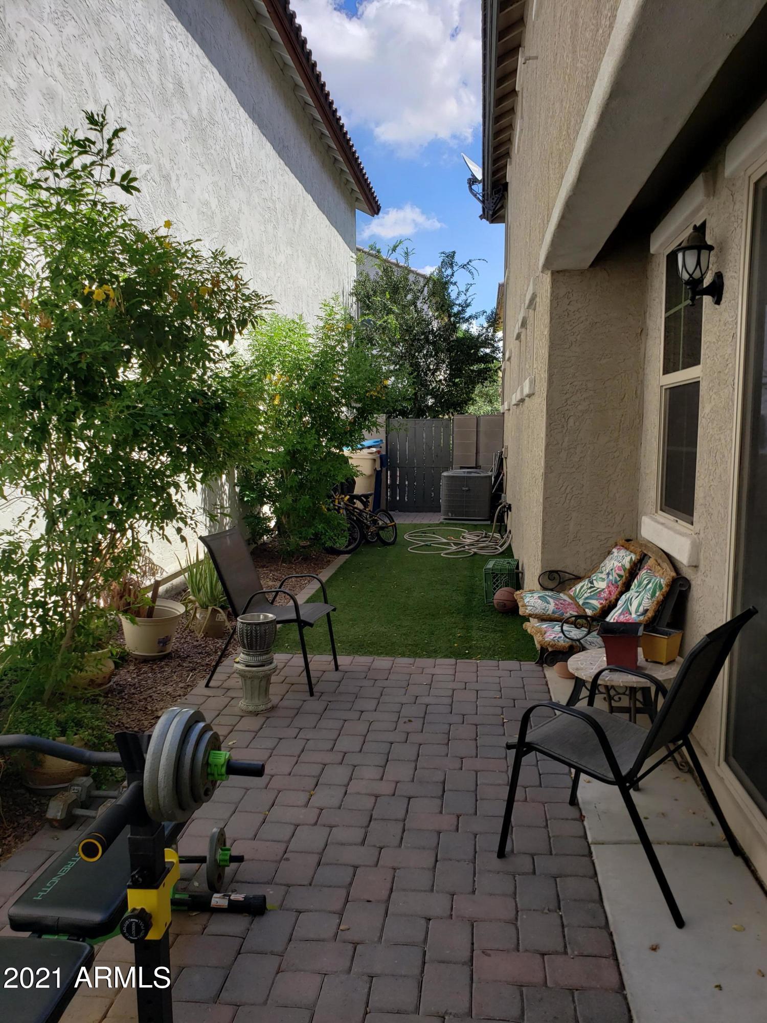 2549 North Riley Road Buckeye, AZ 85396 - Photo 35 of 46 a backyard of a house with table and chairs