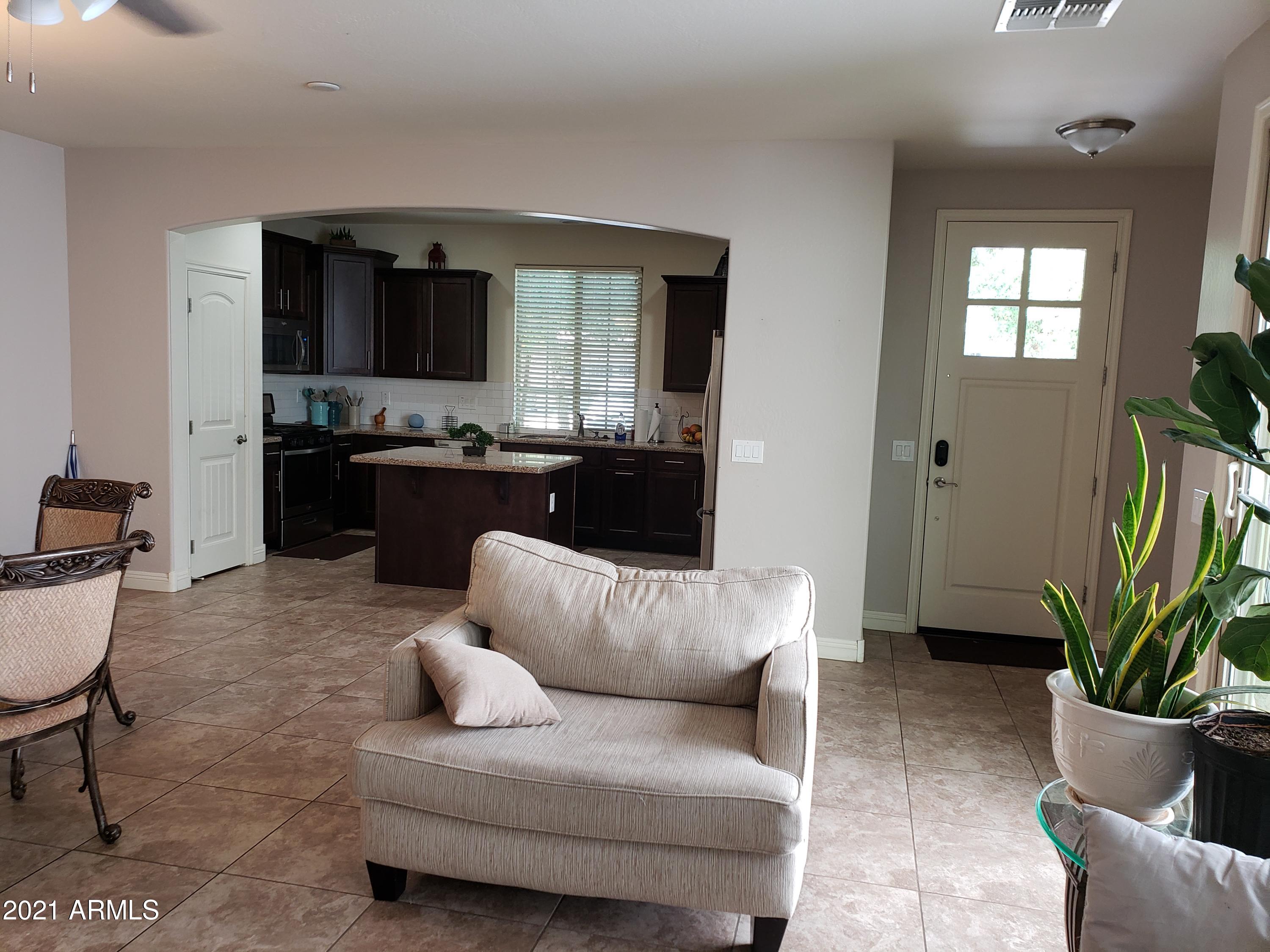 2549 North Riley Road Buckeye, AZ 85396 - Photo 43 of 46 a living room with furniture or couch and a potted plant