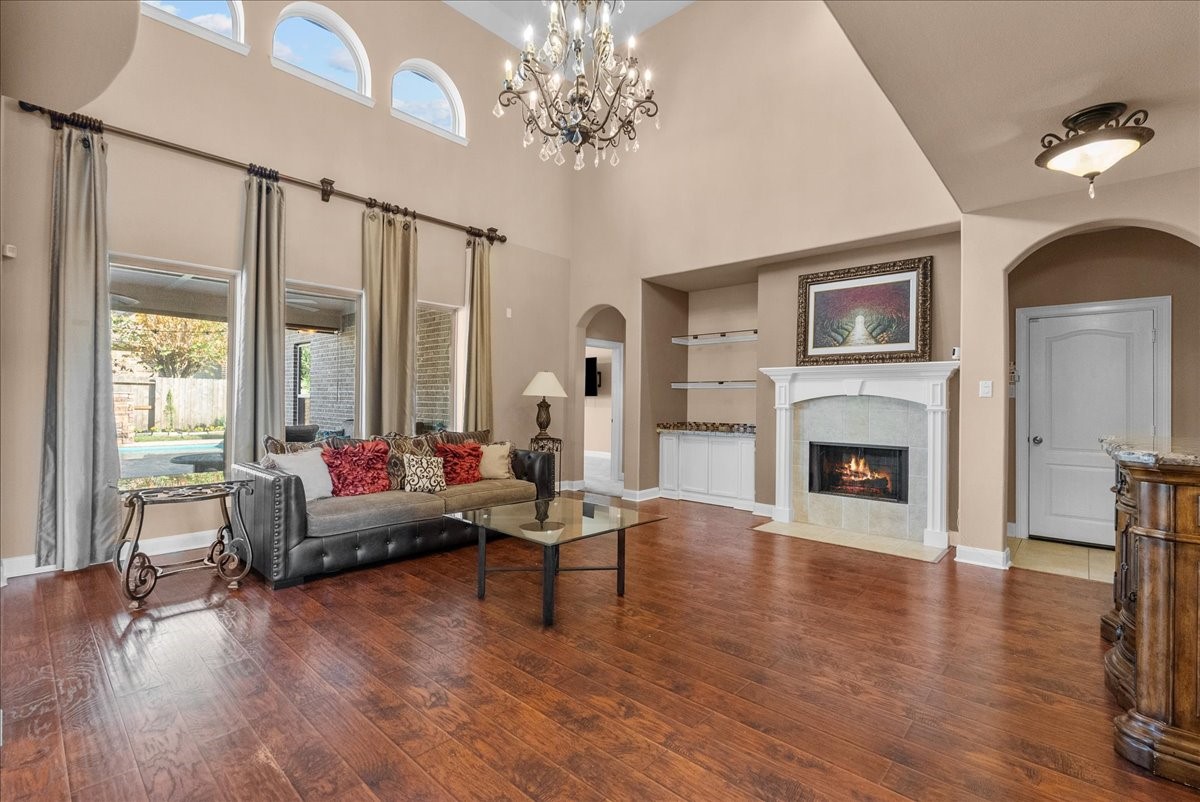 1358 Porta Rosa Lane League City, TX 77573 - Photo 16 of 48 The living room features a cozy fireplace and two-story ceilings