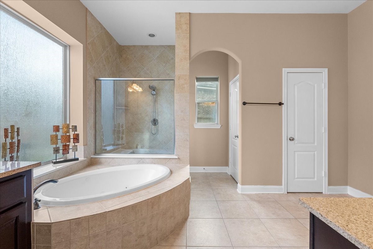 1358 Porta Rosa Lane League City, TX 77573 - Photo 21 of 48 Primary en-suite bath features a walk-in shower, soaking tub, dual vanities and a walk-in closet