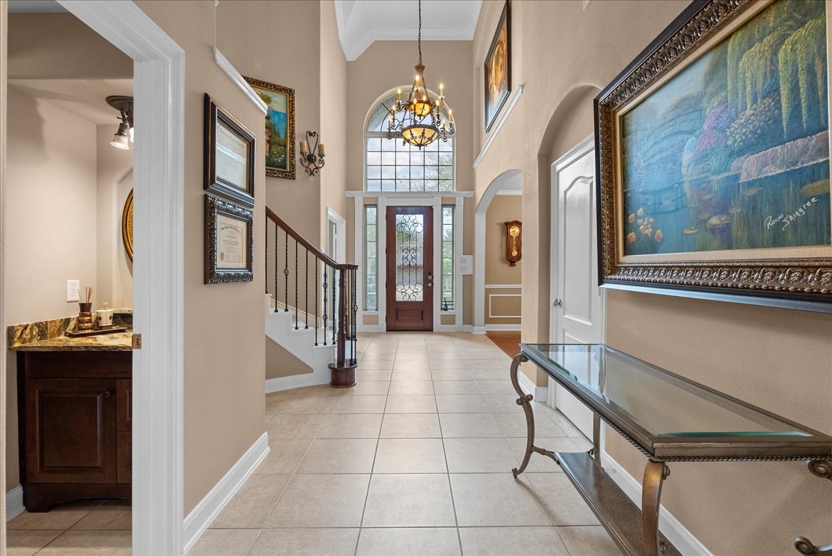 1358 Porta Rosa Lane League City, TX 77573 - Photo 4 of 48 Enter to soaring ceilings and a curved staircase fit for a queen