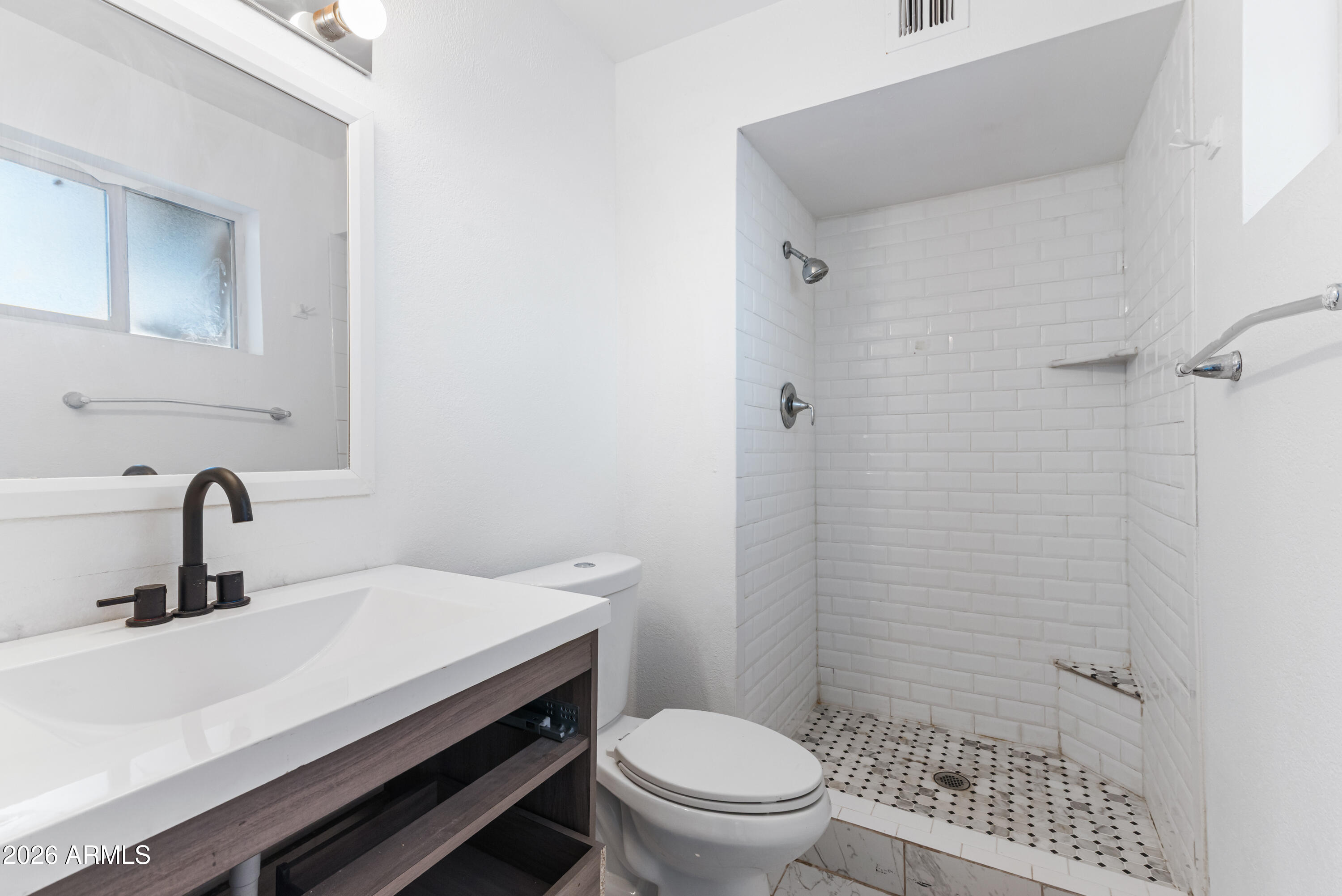 860 West McLellan Road Mesa, AZ 85201 - Photo 15 of 26 a bathroom with a sink a toilet and shower