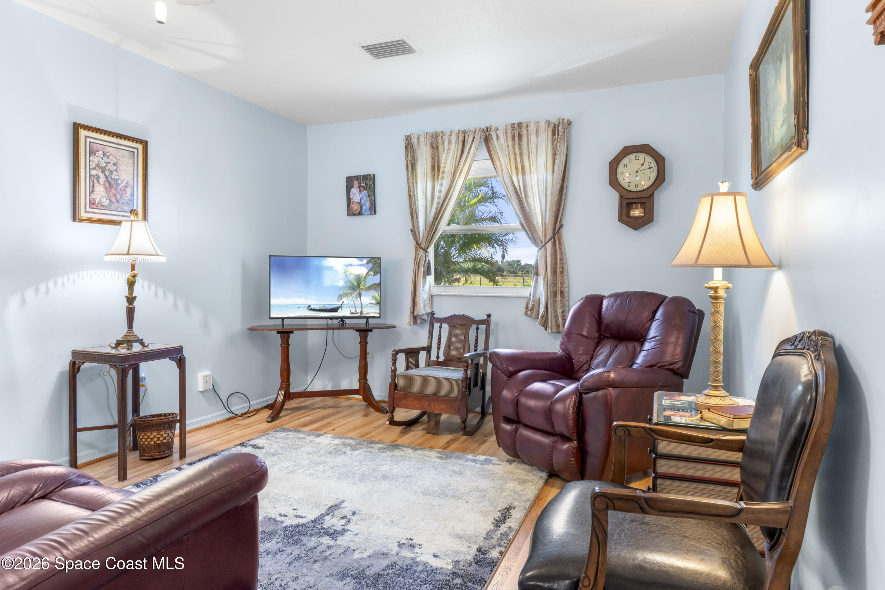 637 Roseland Road Sebastian, FL 32958 - Photo 15 of 36 a living room with furniture a window and a lamp