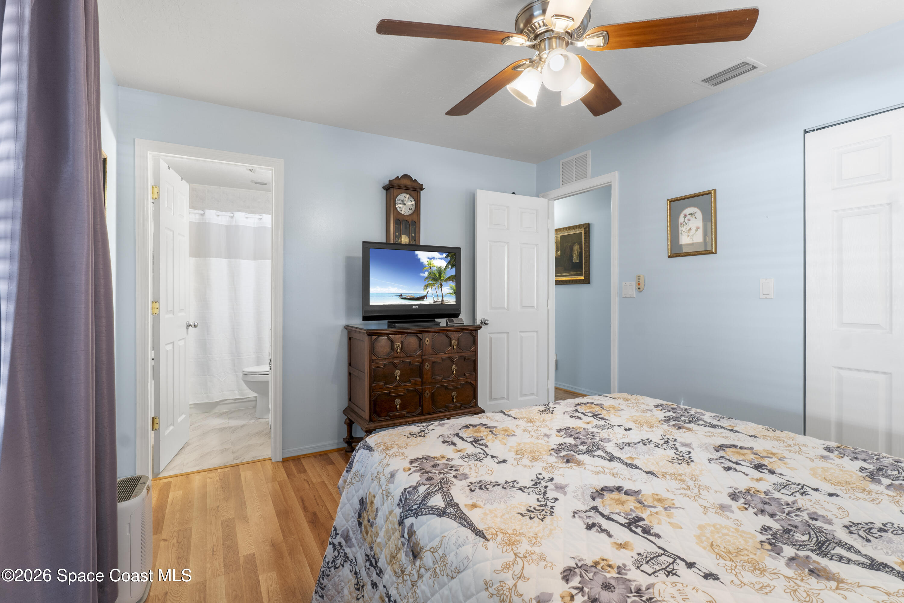 637 Roseland Road Sebastian, FL 32958 - Photo 18 of 36 a bedroom with a bed and a flat screen tv
