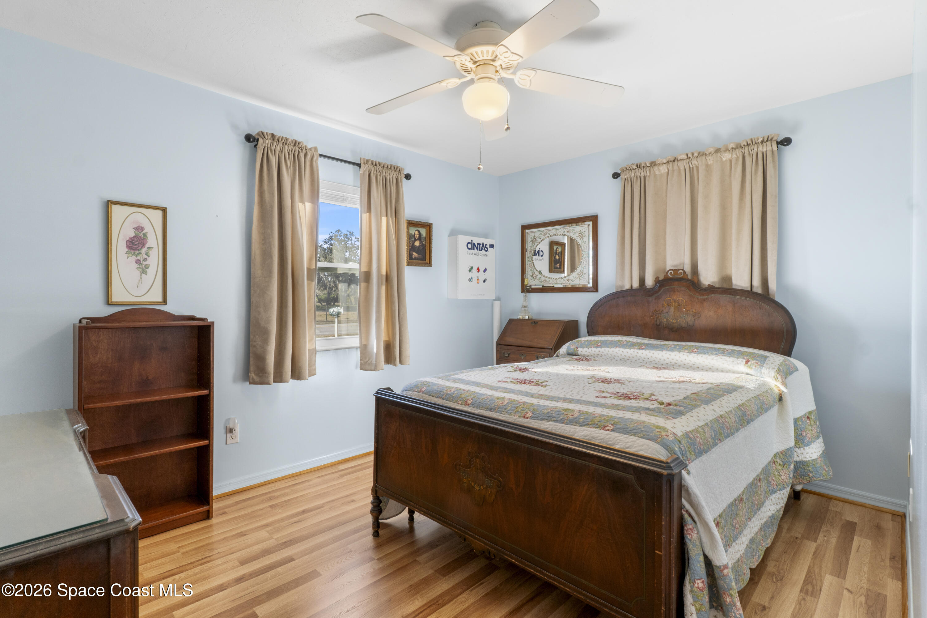 637 Roseland Road Sebastian, FL 32958 - Photo 24 of 36 a bedroom with a bed and a mirror on a dresser