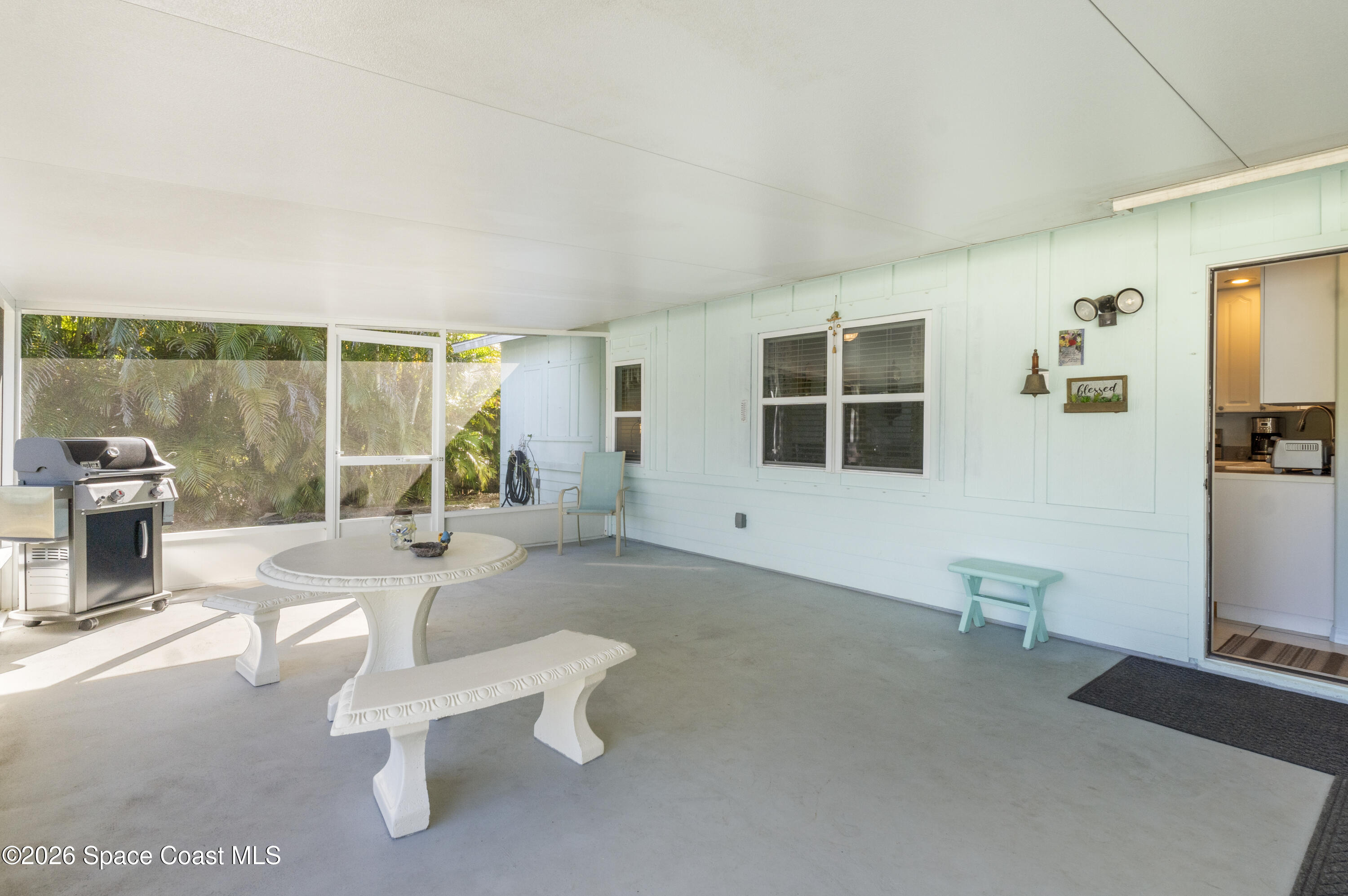 637 Roseland Road Sebastian, FL 32958 - Photo 28 of 36 a living room with furniture a flat screen tv and a large window