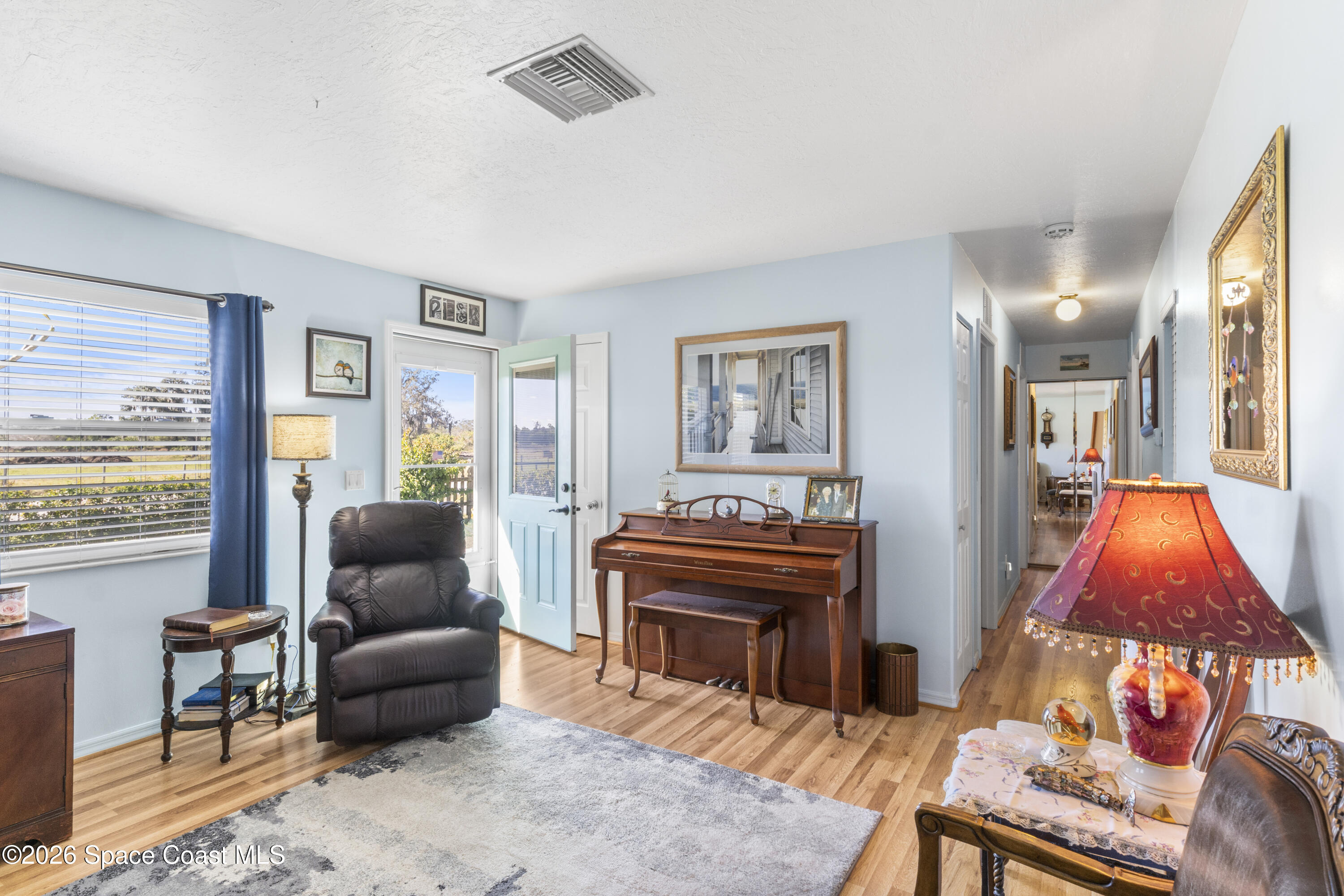637 Roseland Road Sebastian, FL 32958 - Photo 6 of 36 a living room with furniture a rug and a piano