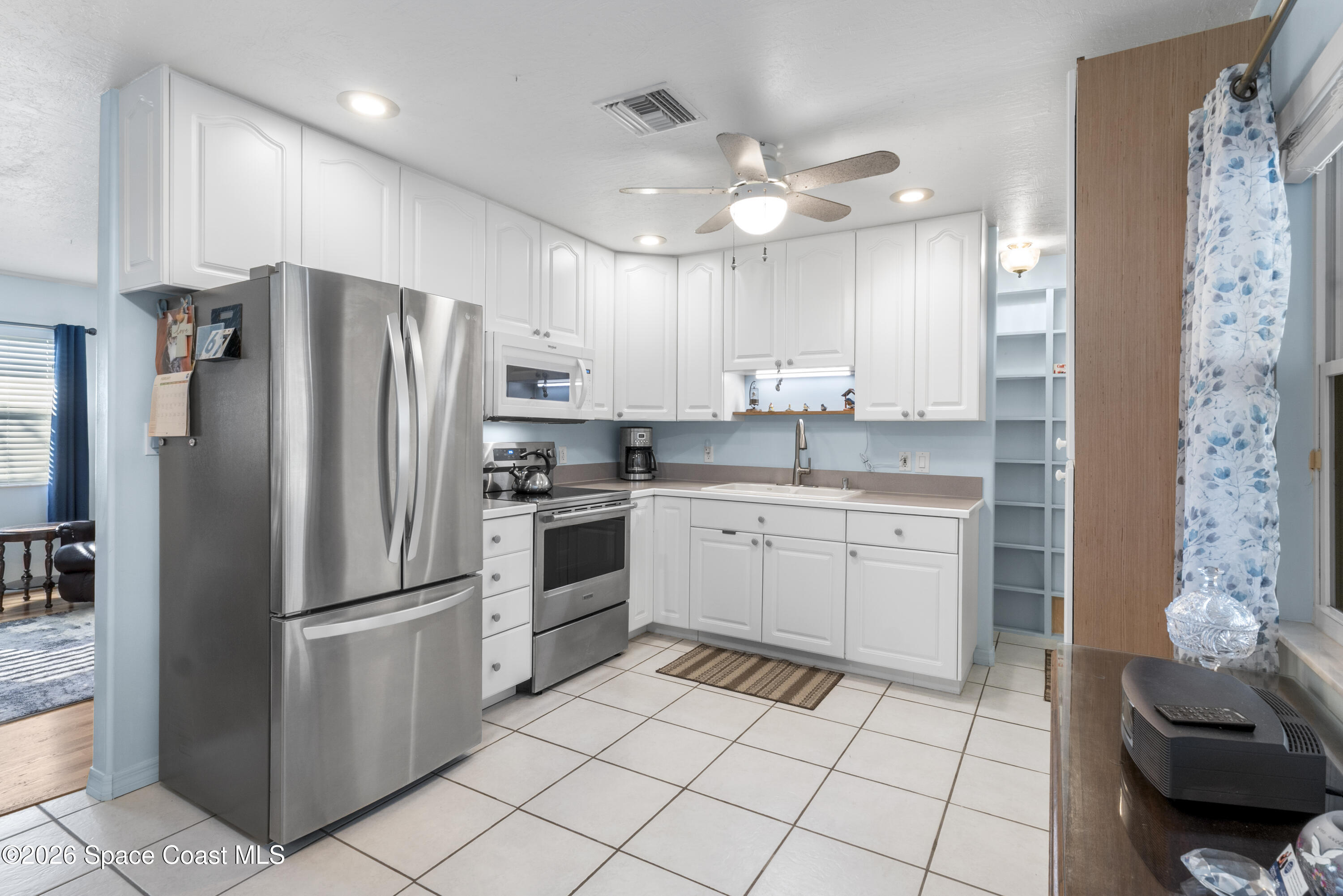 637 Roseland Road Sebastian, FL 32958 - Photo 9 of 36 a kitchen with a refrigerator sink and cabinets