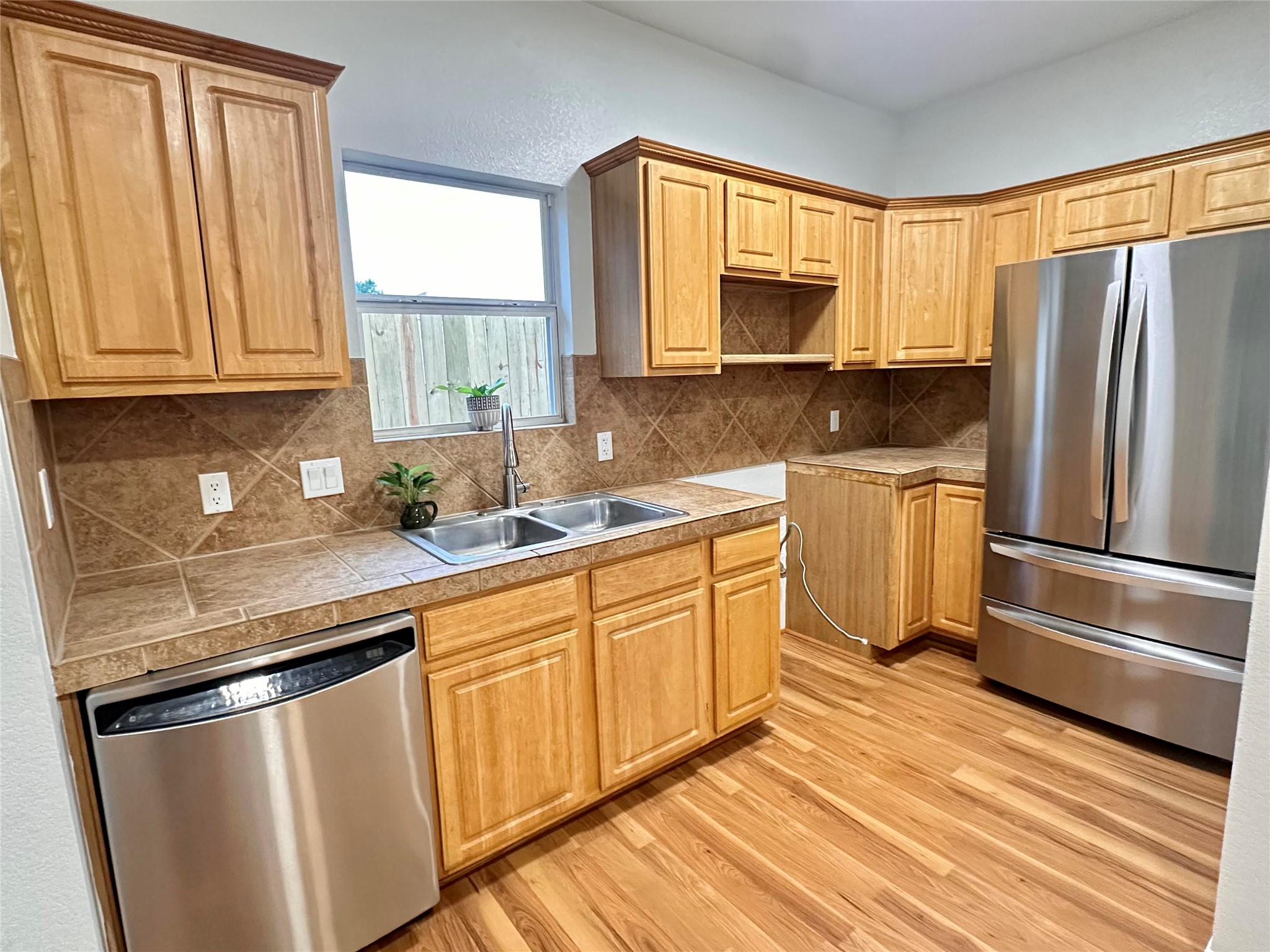 1122 Mansell Avenue Austin, TX 78721 - Photo 6 of 29 a kitchen with granite countertop stainless steel appliances a sink window and cabinets