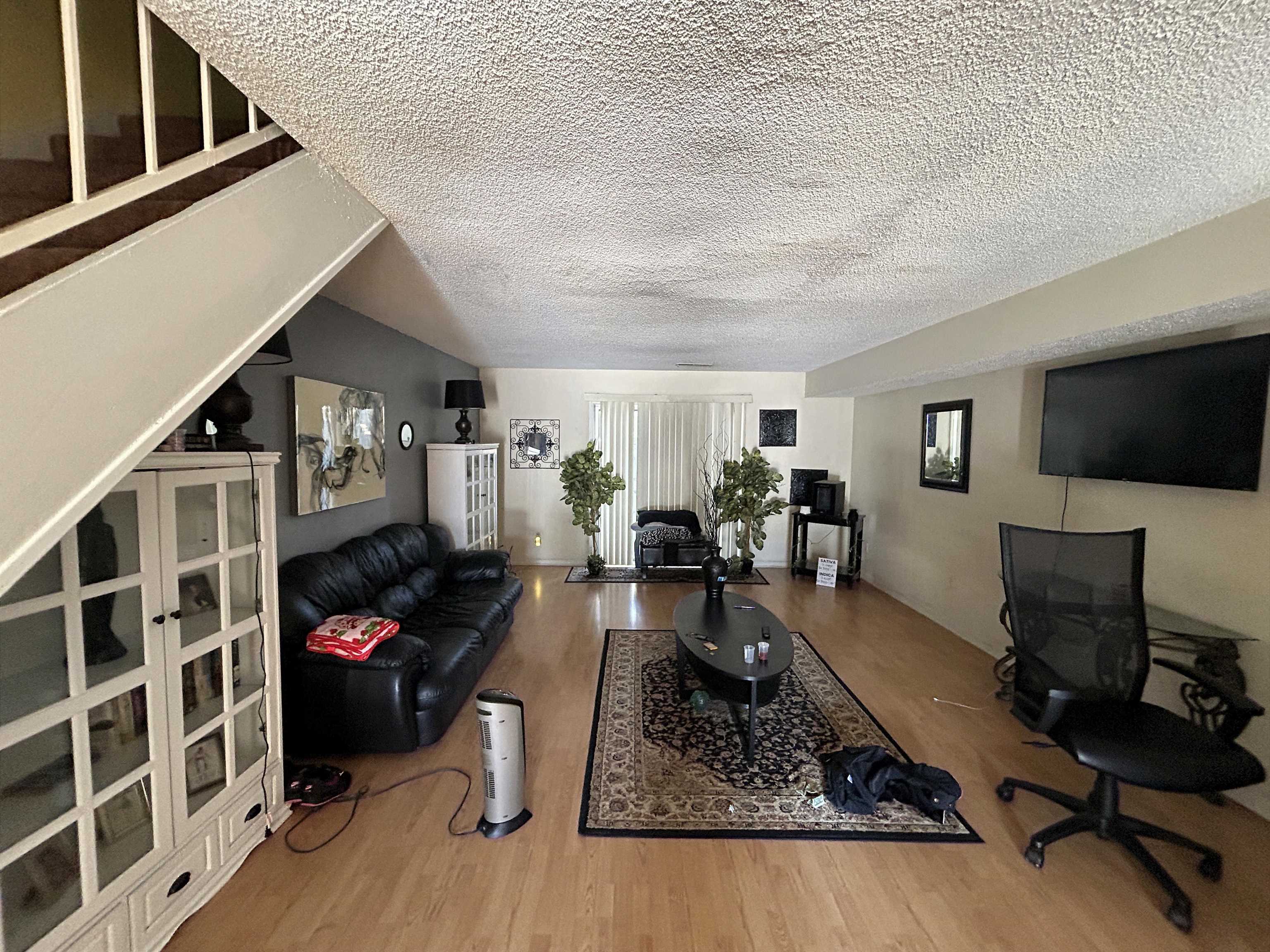 3748 Station Way Memphis, TN 38115 - Photo 3 of 11 Living area featuring wood finished floors and a textured ceiling