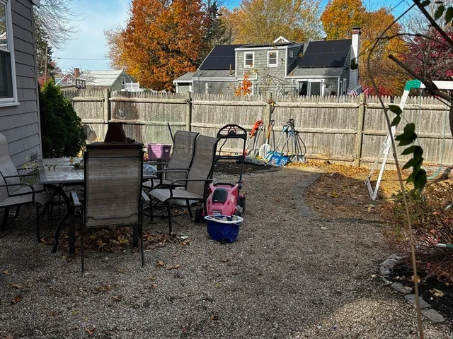 a view of roof deck with dining table and chairs