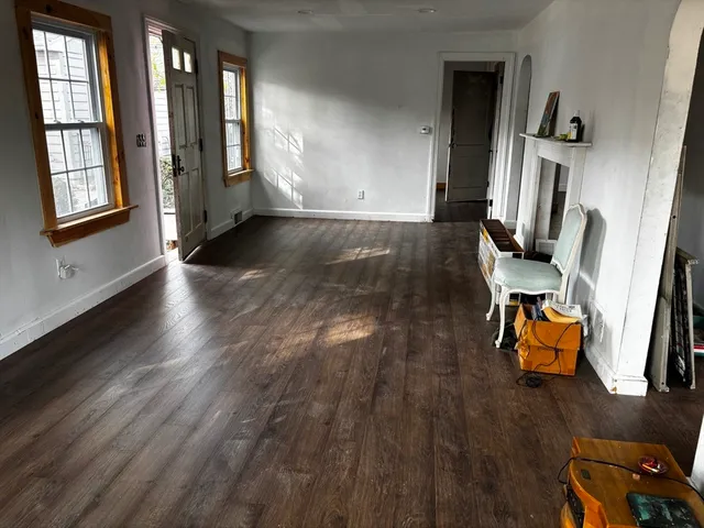 wooden floor with windows and lounge chair