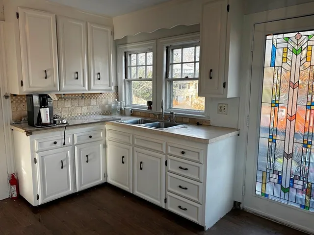 a spacious bathroom with double vanity and a window