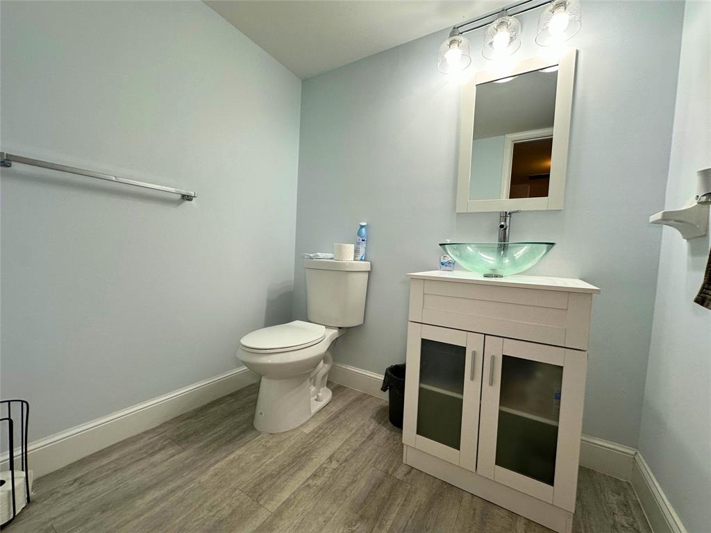 2420 DC Country Club Boulevard, Unit 306 Deerfield Beach, FL 33442 - Photo 12 of 23 a bathroom with a toilet a sink and mirror
