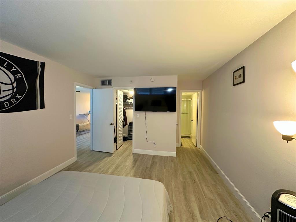 2420 DC Country Club Boulevard, Unit 306 Deerfield Beach, FL 33442 - Photo 14 of 23 a spacious bedroom with a bed and a view of bathroom