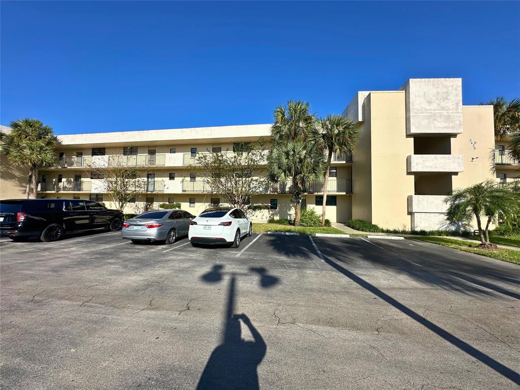 2420 DC Country Club Boulevard, Unit 306 Deerfield Beach, FL 33442 - Photo 23 of 23 a view of a parking area