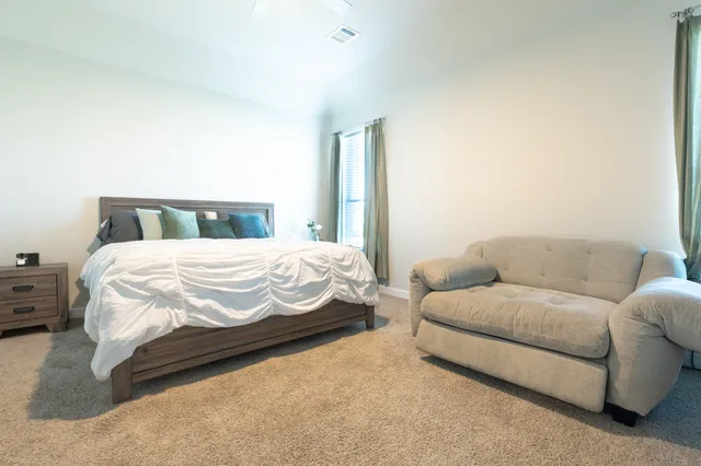 a bedroom with a bed and couch