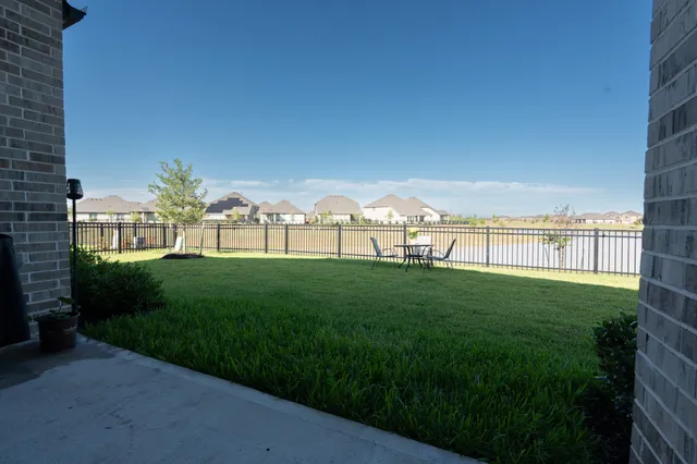 a view of a garden with a building in the background