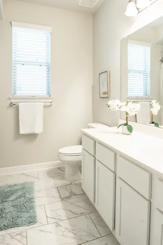 a bathroom with a sink toilet and mirror
